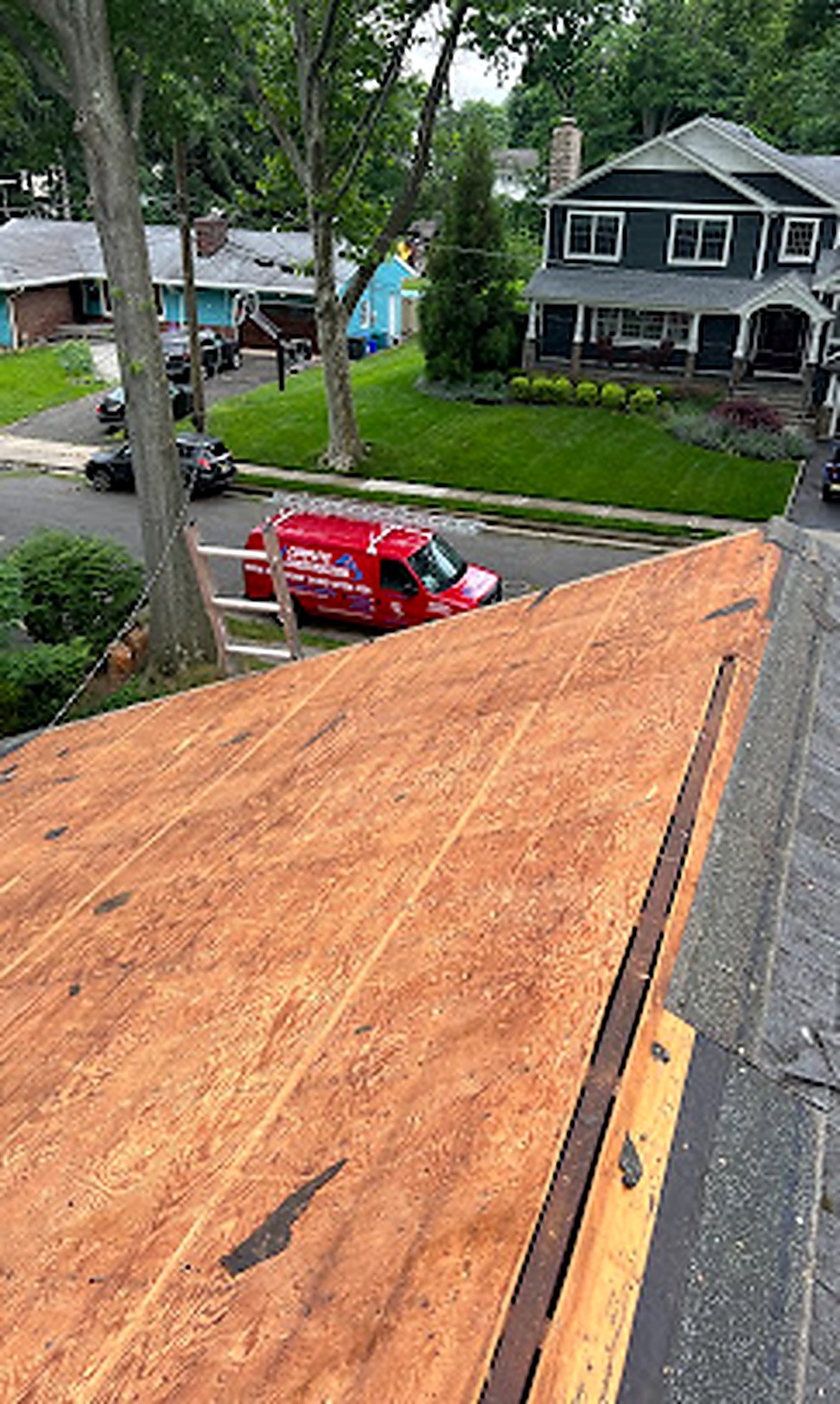 1 All American Roofing branded red van in customer driveway during job